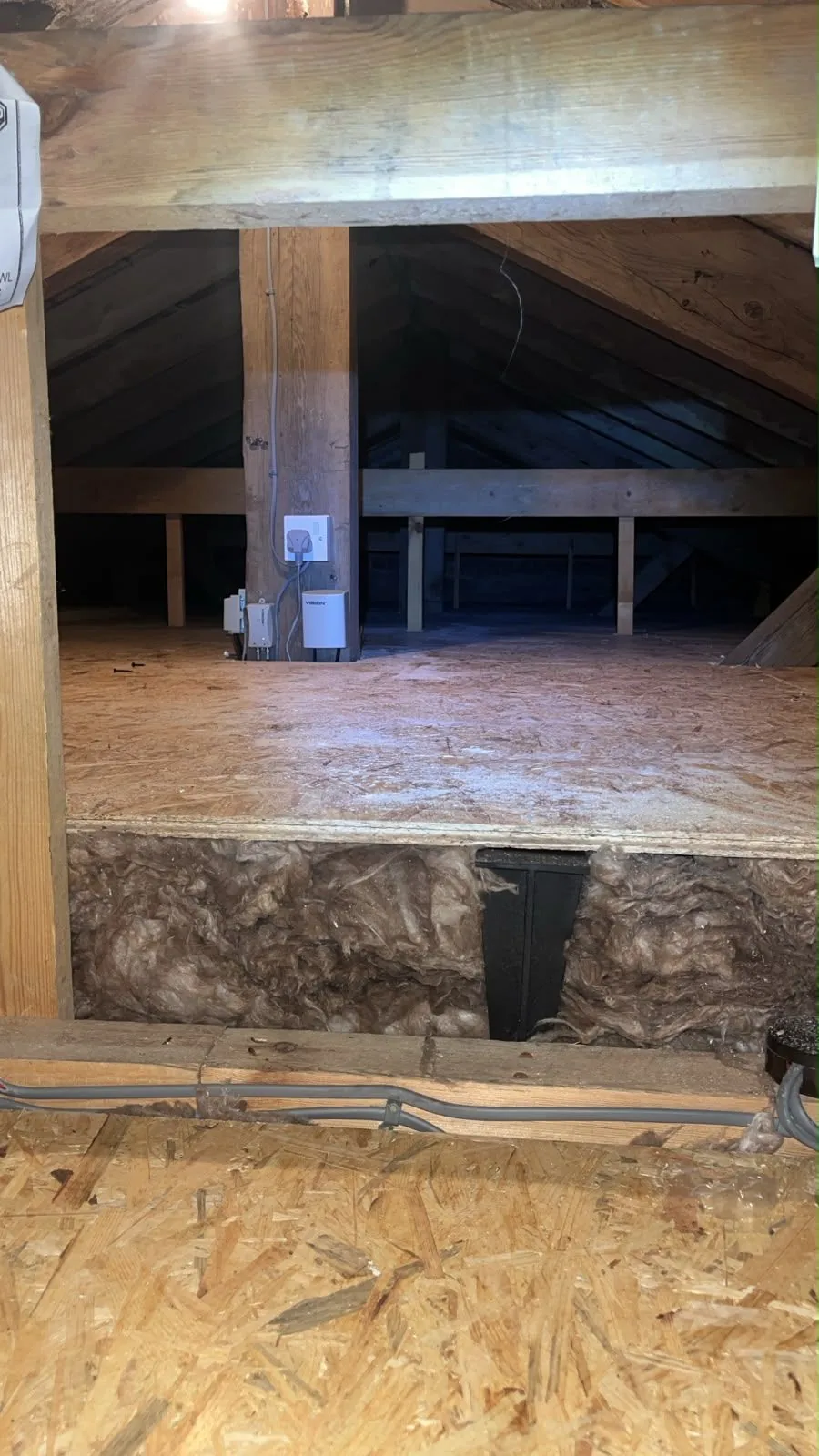 Boarded loft platform with the full depth of insulation visible beneath the deck edge